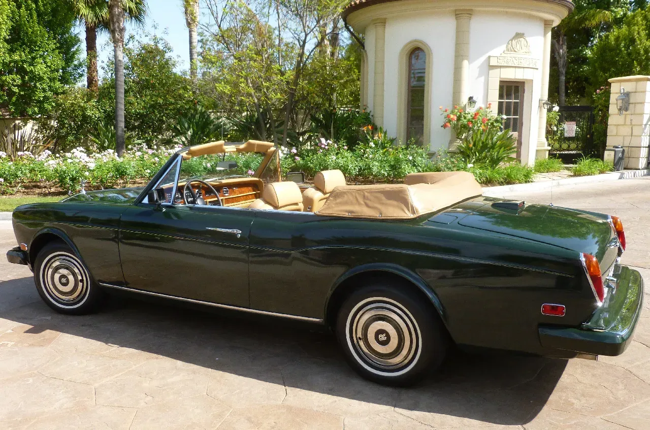Green 1983 Rolls Royce Corniche Convertible exterior with convertible roof for wedding car rental in Hidden Valley Lake, CA
