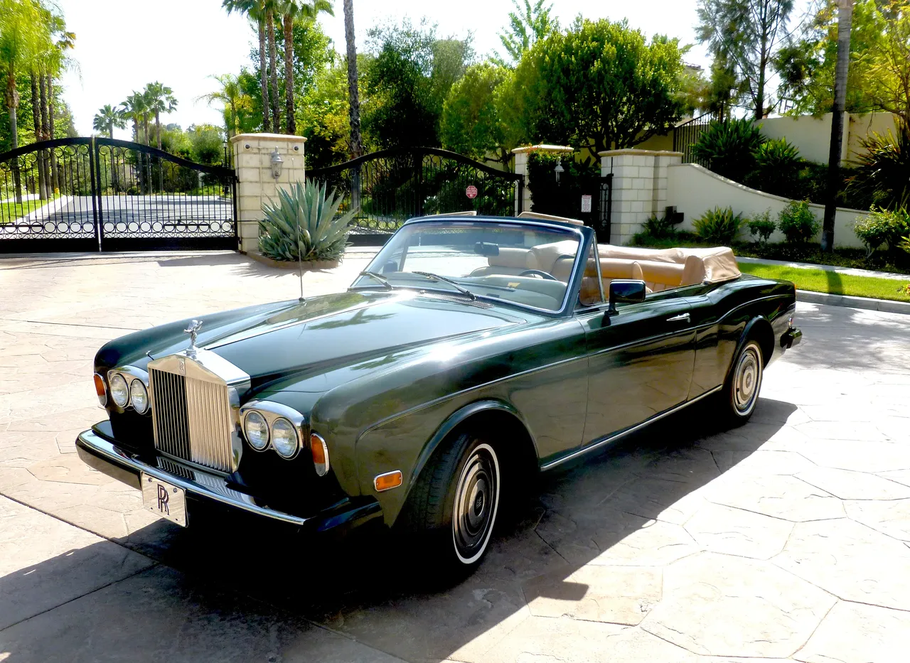Green 1983 Rolls Royce Corniche Convertible with convertible roof for wedding car rental in Hidden Valley Lake, CA