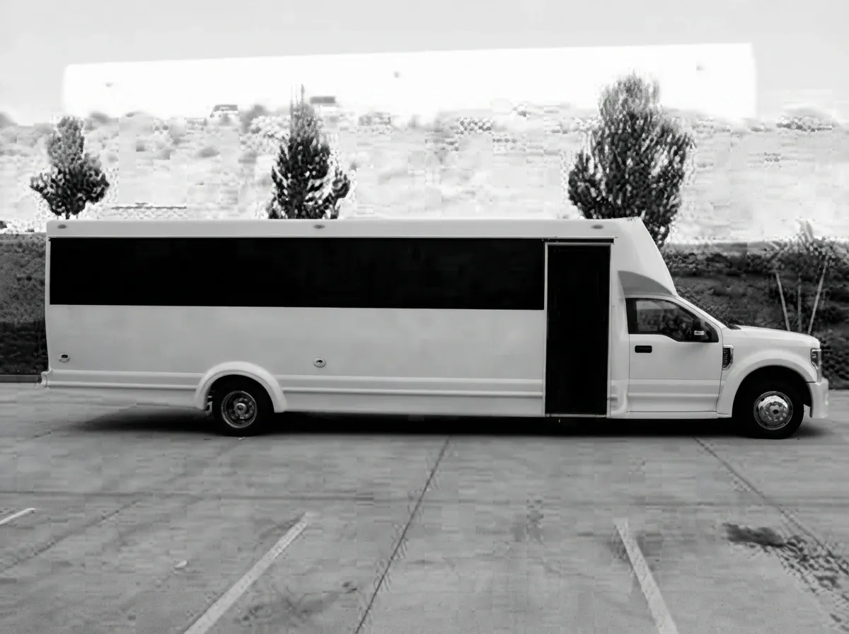The white 2019 Ford F550 30 Passenger Luxury Limousine Bus, ready to rent