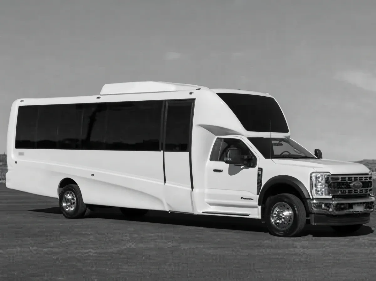 The white 2024 Ford F550 Luxury Coach 27-passenger, ready to rent
