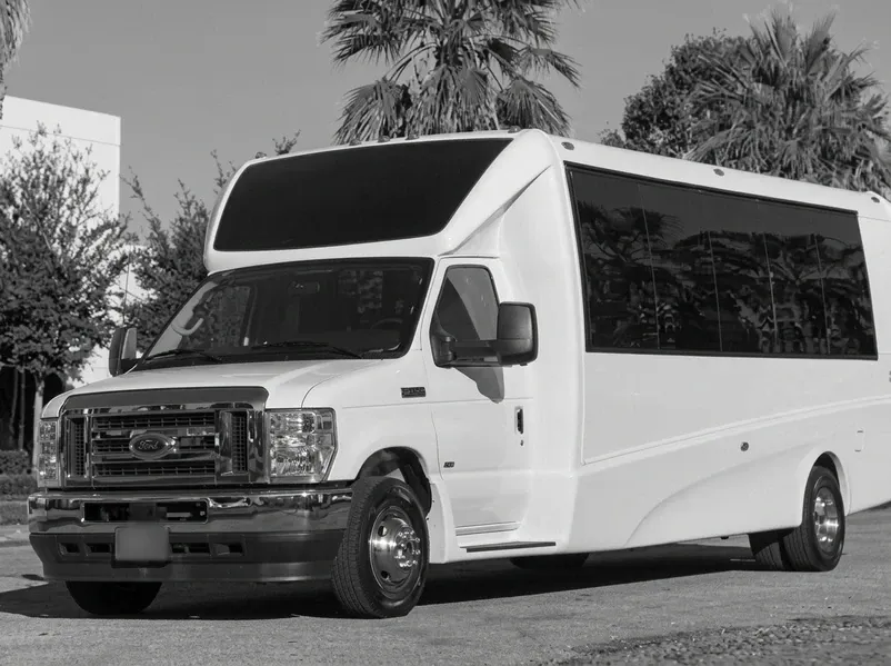 The white 23 Passenger 2025 E-450 Luxury Coach, ready to rent