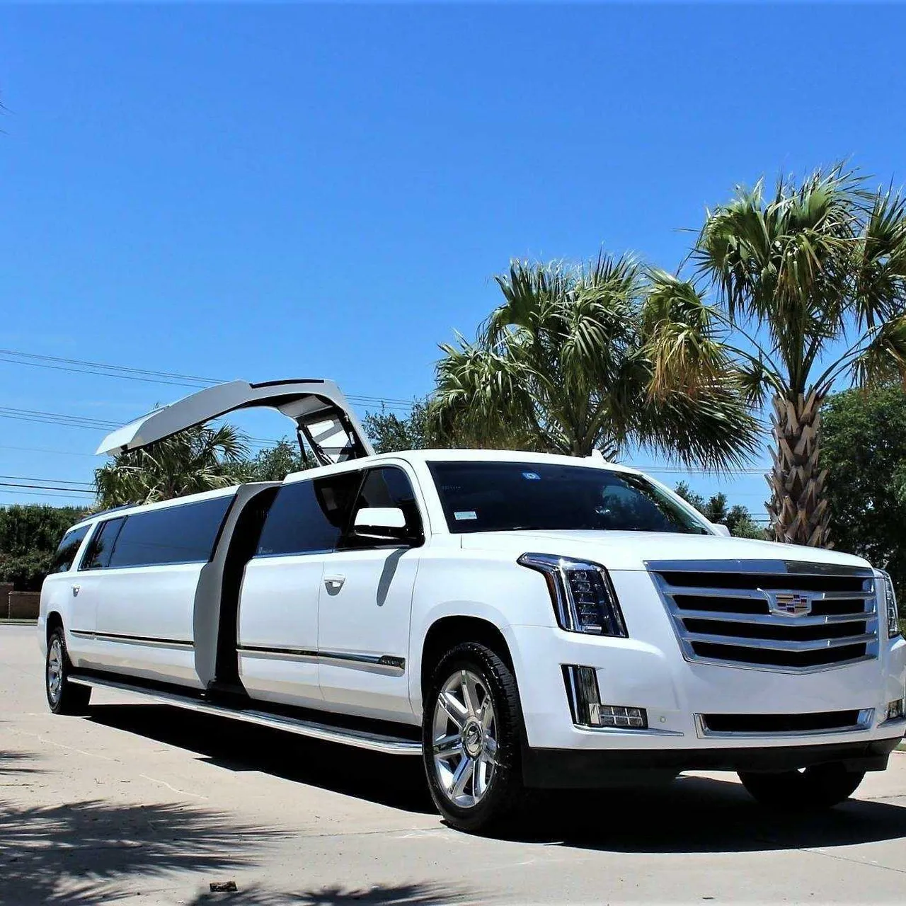 White Cadillac Escalade Limo with tinted windows for limo rental