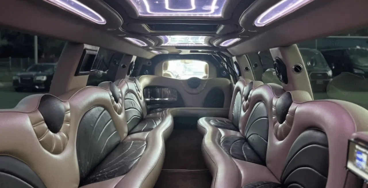 Cadillac Escalade Limousine interior with perimeter lounge seating and LED ceiling lighting for limo rental in Atlanta, GA
