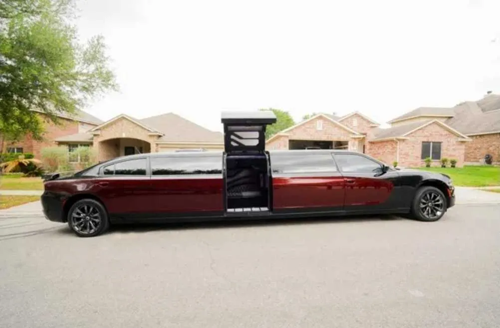 Black Charger Limousine with tinted windows and bridal (jet) door for limo rental in Schertz, TX