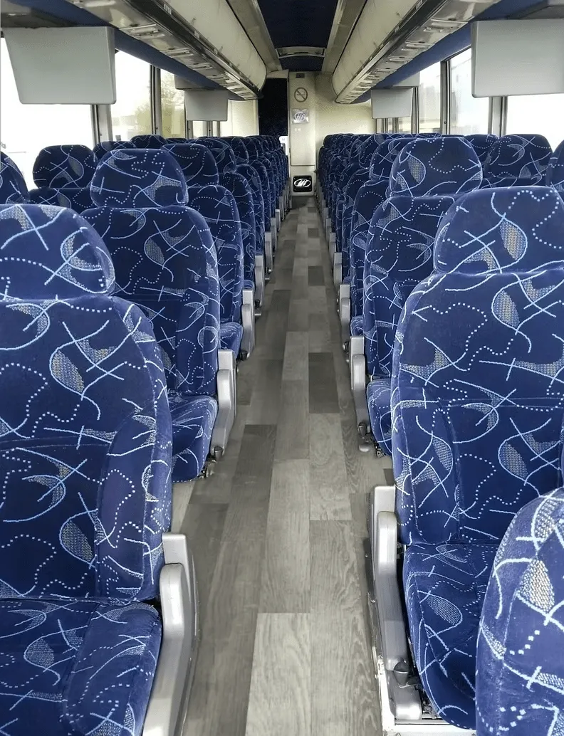 56 Passenger Charter Bus interior with overhead parcel racks for charter bus rental