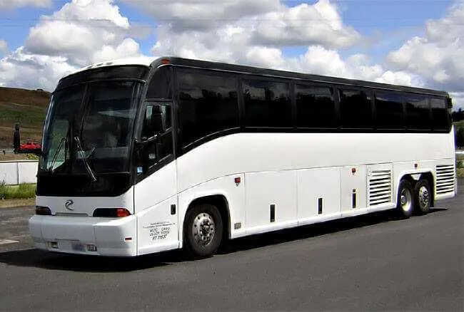 White 30 Passenger Charter Bus with tinted windows for charter bus rental in Dallas, TX