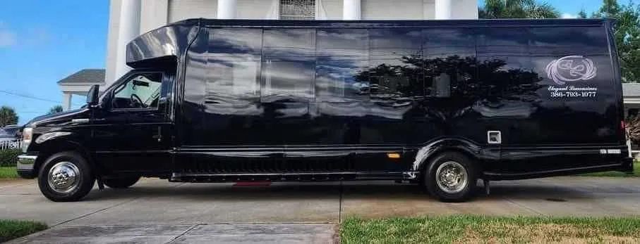 From outside of the black 2019 Luxury Party Bus (Dark Shadow), showing tinted windows, shot 4
