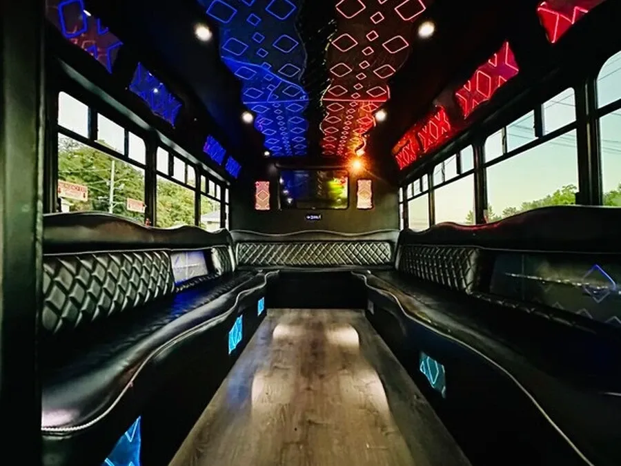 The white Ford E-450 Series Party Bus, shot 2