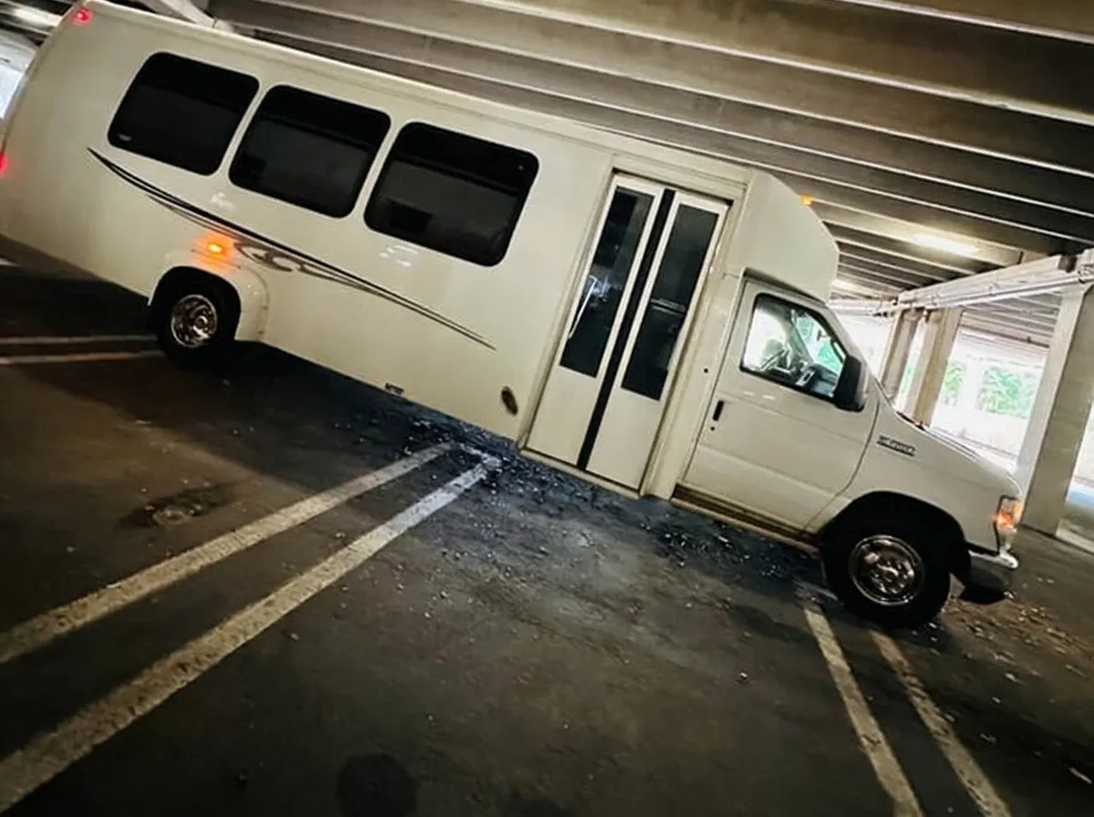 The white Ford E-450 Series Party Bus, shot 7