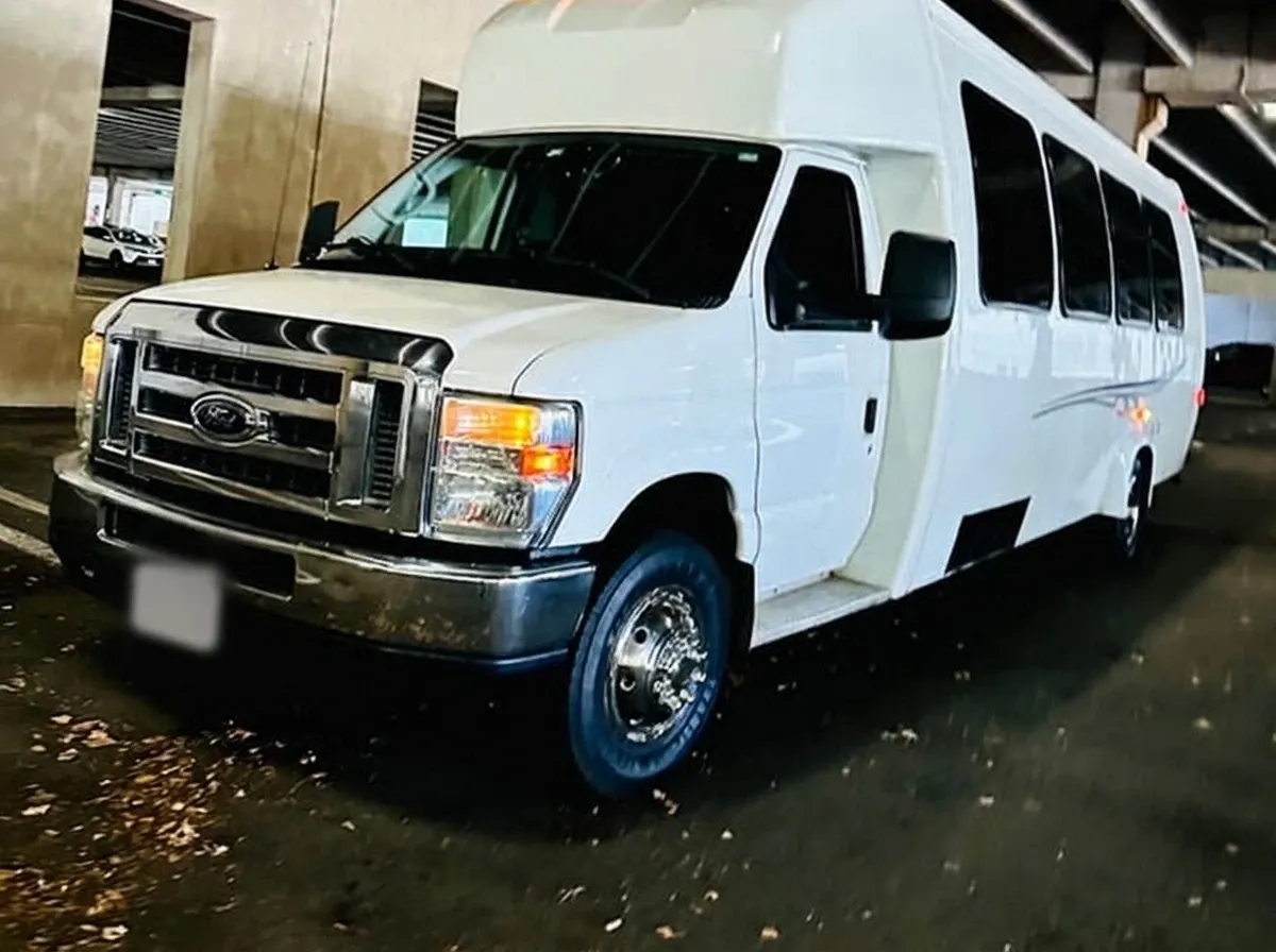 The white Ford E-450 Series Party Bus, shot 9