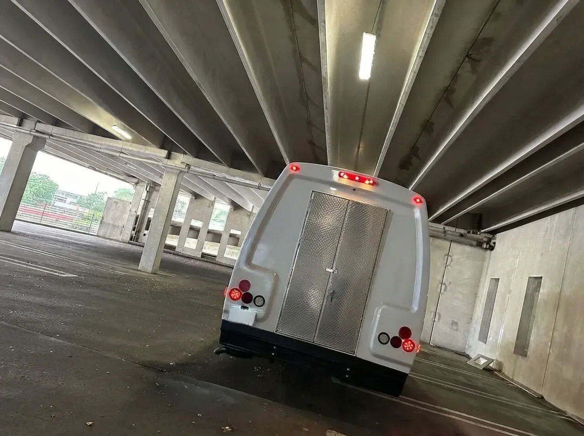 The white Ford E-450 Series Party Bus, shot 2