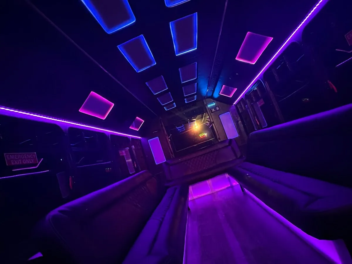 Ford E-450 Series Party Bus interior with perimeter lounge seating, LED accent lighting and LED ceiling lighting, photo 3 for party bus rental in North Attleboro, MA