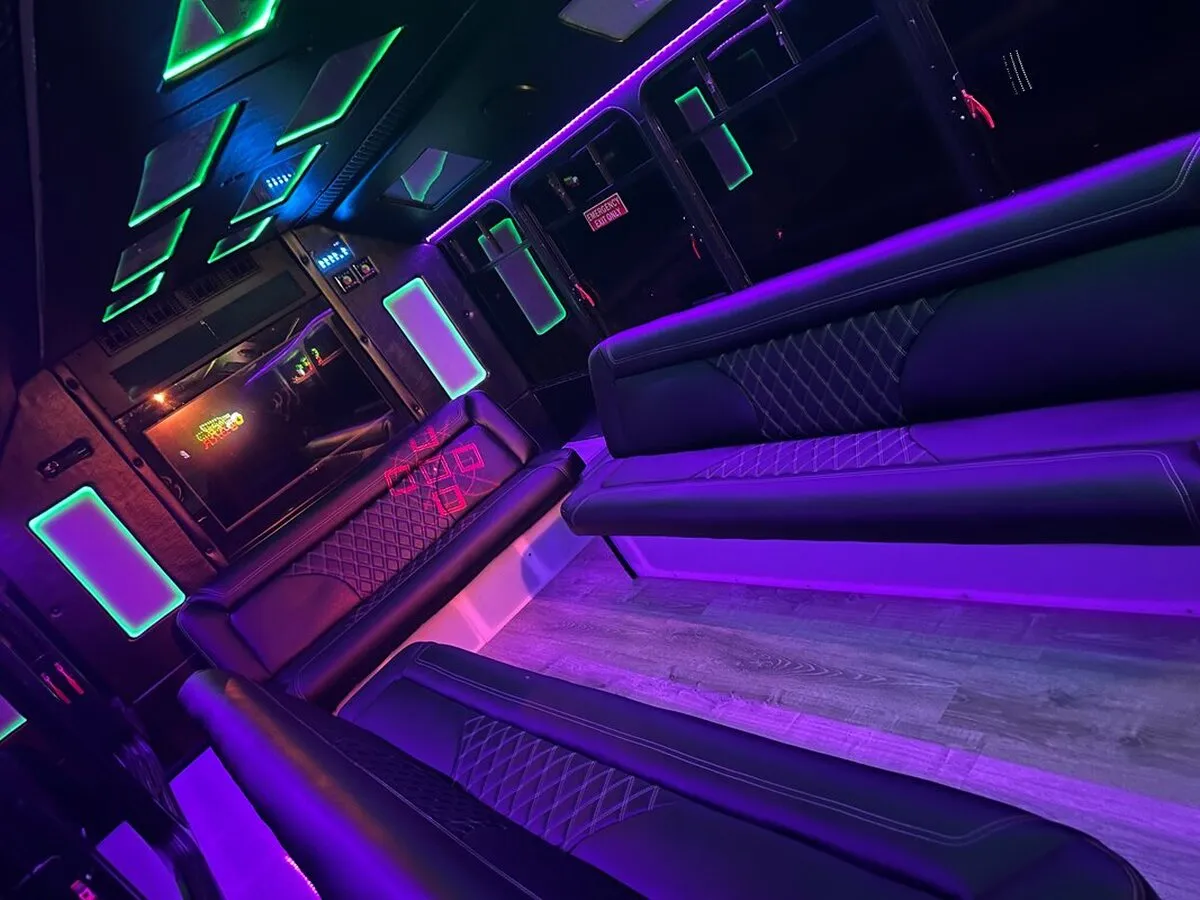 Ford E-450 Series Party Bus interior with perimeter lounge seating, LED accent lighting and LED ceiling lighting, photo 4 for party bus rental in North Attleboro, MA