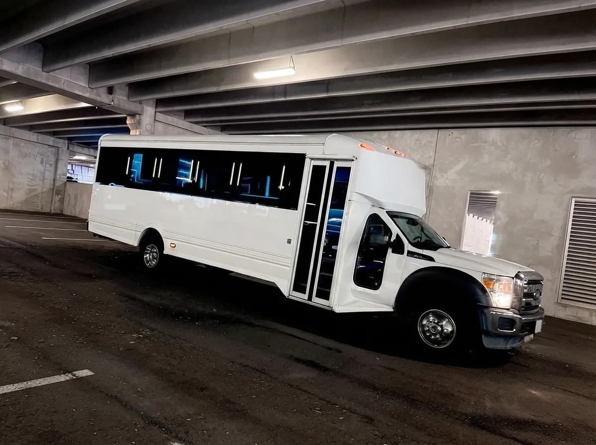 The white Ford F-550 Party Bus, ready to rent