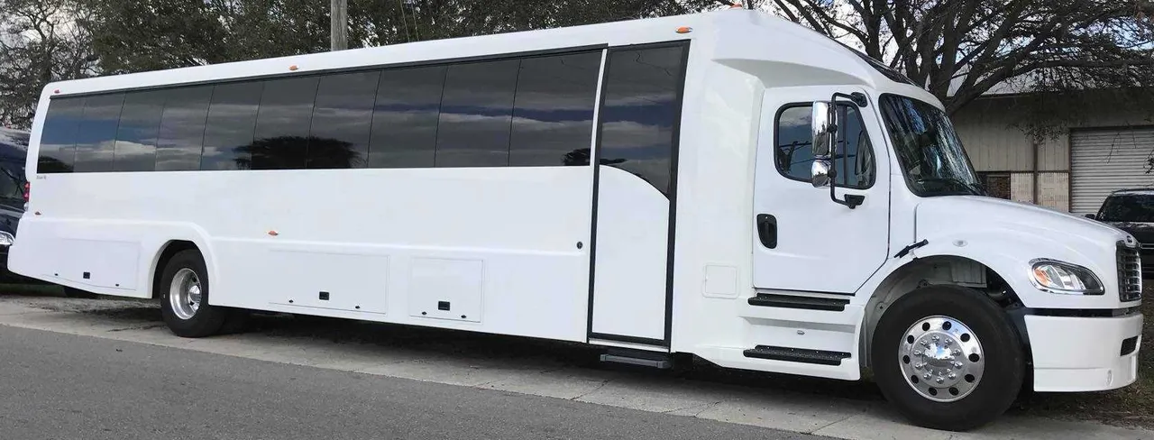 White Freightliner Luxury Coach with tinted windows for charter bus rental