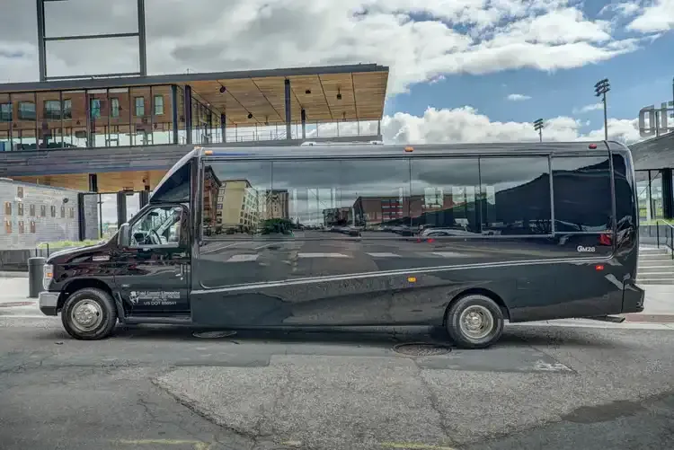 Black Grech Party Bus exterior with tinted windows, photo 4 for party bus rental in Saint Paul, MN