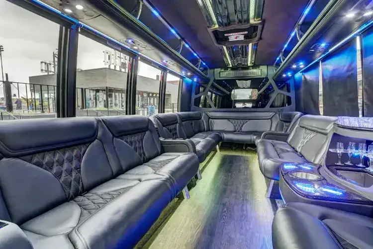 Grech Party Bus interior with perimeter lounge seating, sofa-style seating and LED accent lighting for party bus rental