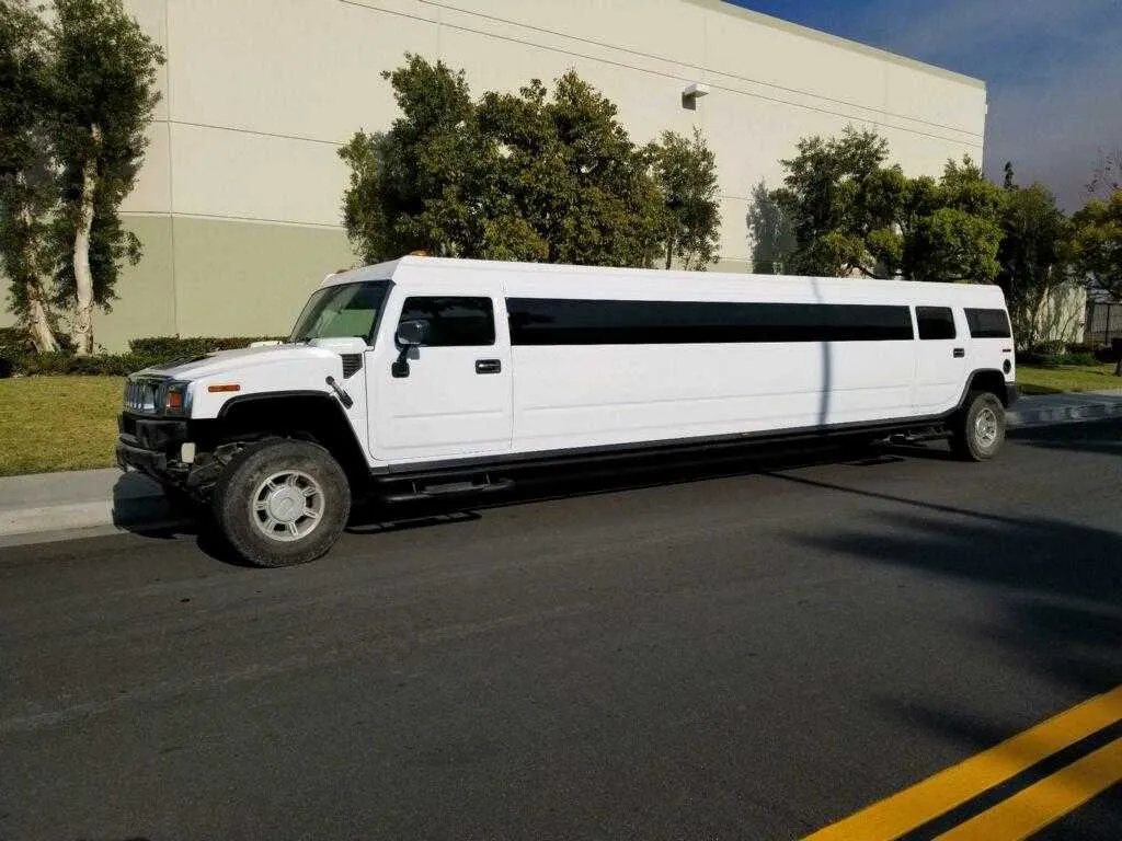 White Hummer Limousine with tinted windows for limo rental