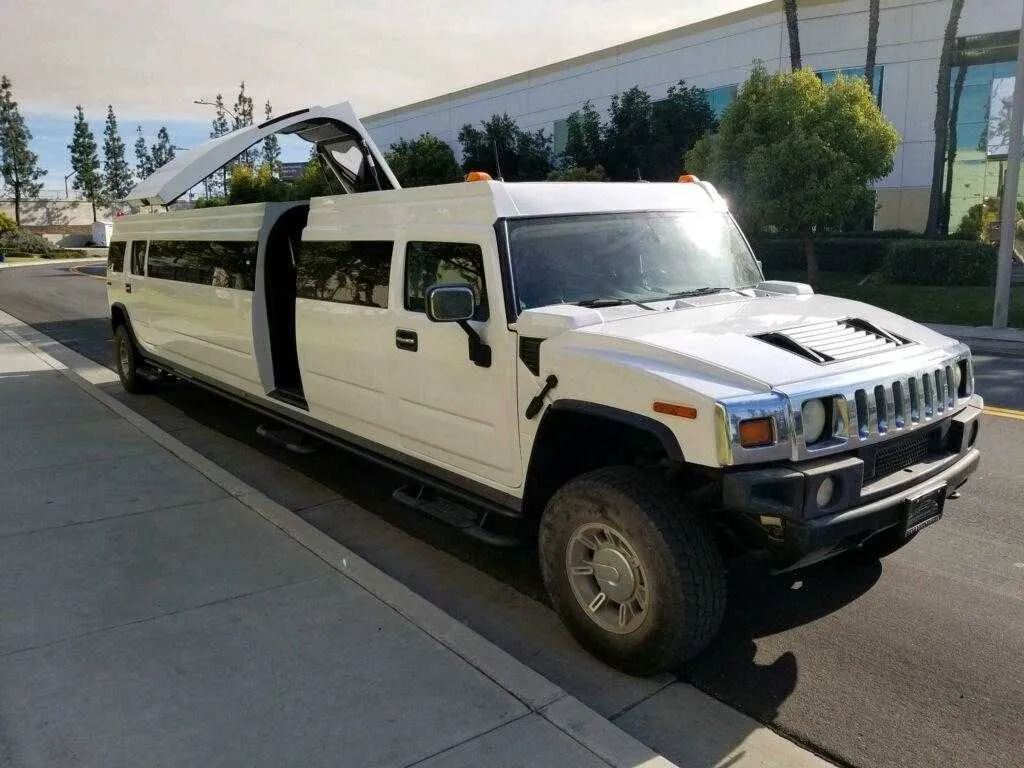 White Hummer Limousine exterior with tinted windows and bridal (jet) door for limo rental