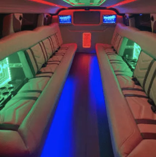 Inside of the Hummer Limousine, showing perimeter lounge seating, LED accent lighting and TV screens