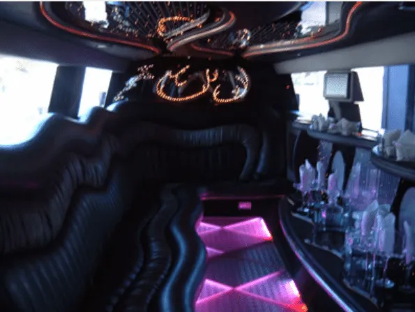 Inside of the Hummer Limousine, showing lit dance floor and bar area