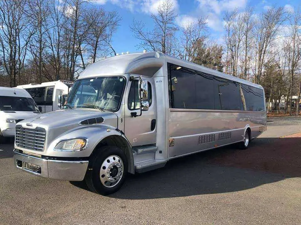 Silver Limousine Bus exterior with tinted windows for party bus rental