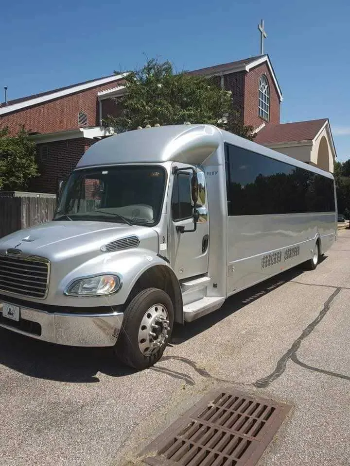 Silver Limousine Bus exterior with tinted windows, photo 5 for party bus rental