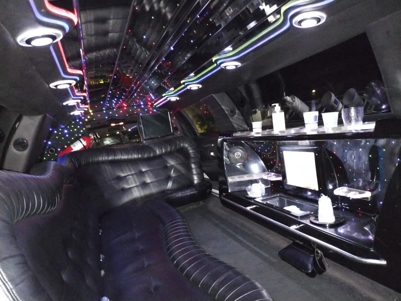 Lincoln Limousine interior with LED ceiling lighting, starlight or fiber-optic ceiling and bar area for limo rental in San Diego, CA