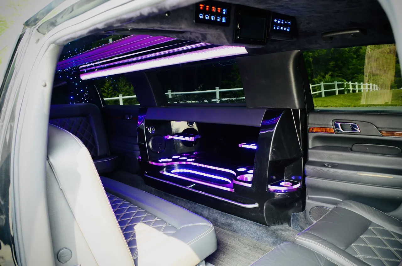 Lincoln MKT Limousine interior with LED accent lighting, LED ceiling lighting and bar area for limo rental