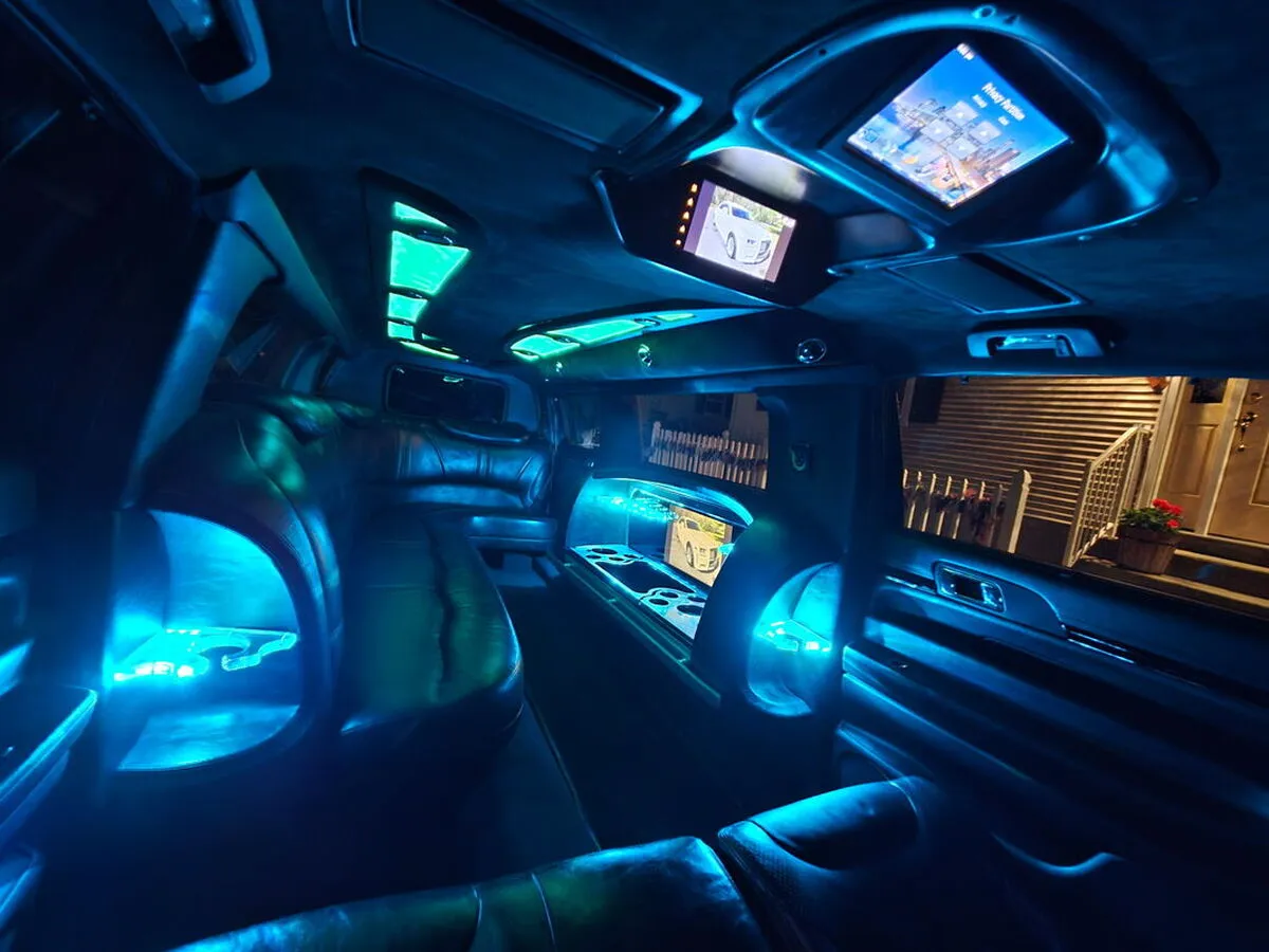 Lincoln MKT Limousine interior with LED accent lighting and TV screens for limo rental