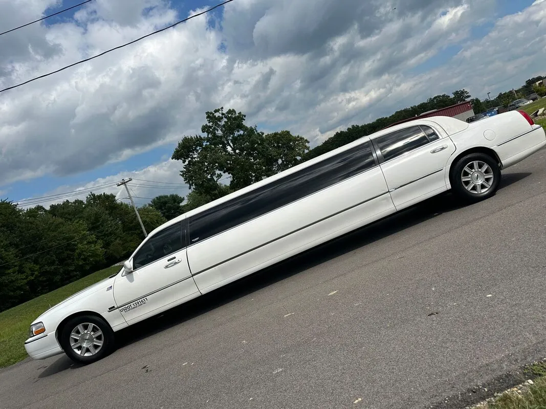 White Lincoln Town Car Limousine exterior with tinted windows, photo 4 for limo rental