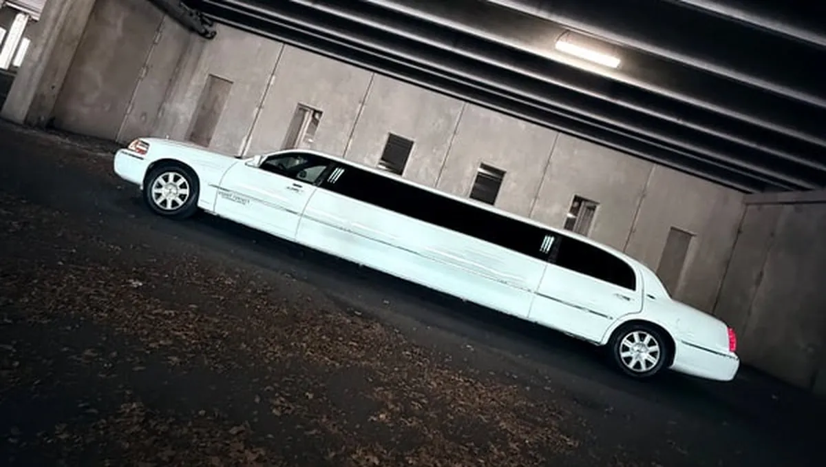 White Lincoln Town Car Limousine exterior with tinted windows for limo rental