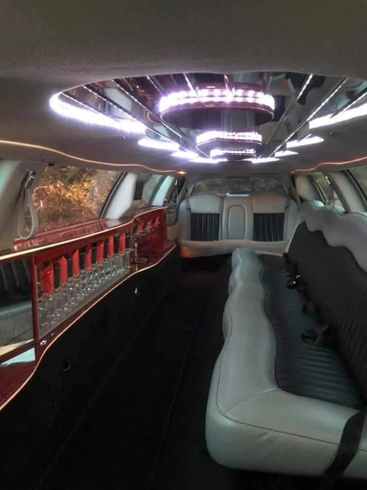 Lincoln Town Car interior with LED ceiling lighting and bar area for limo rental