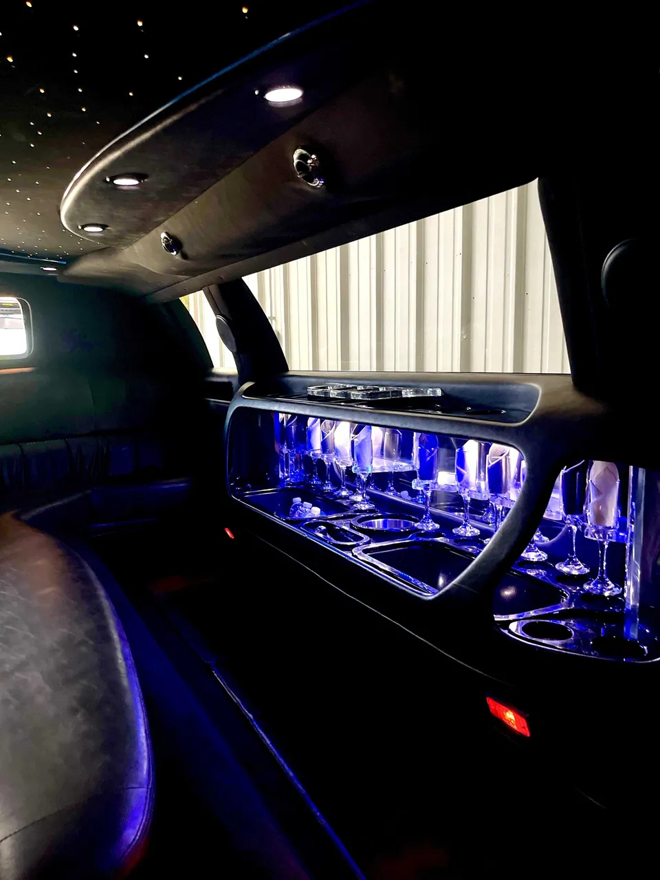 Lincoln Town Car Limousine interior with LED accent lighting, starlight or fiber-optic ceiling and glassware holders for limo rental in Denair, CA