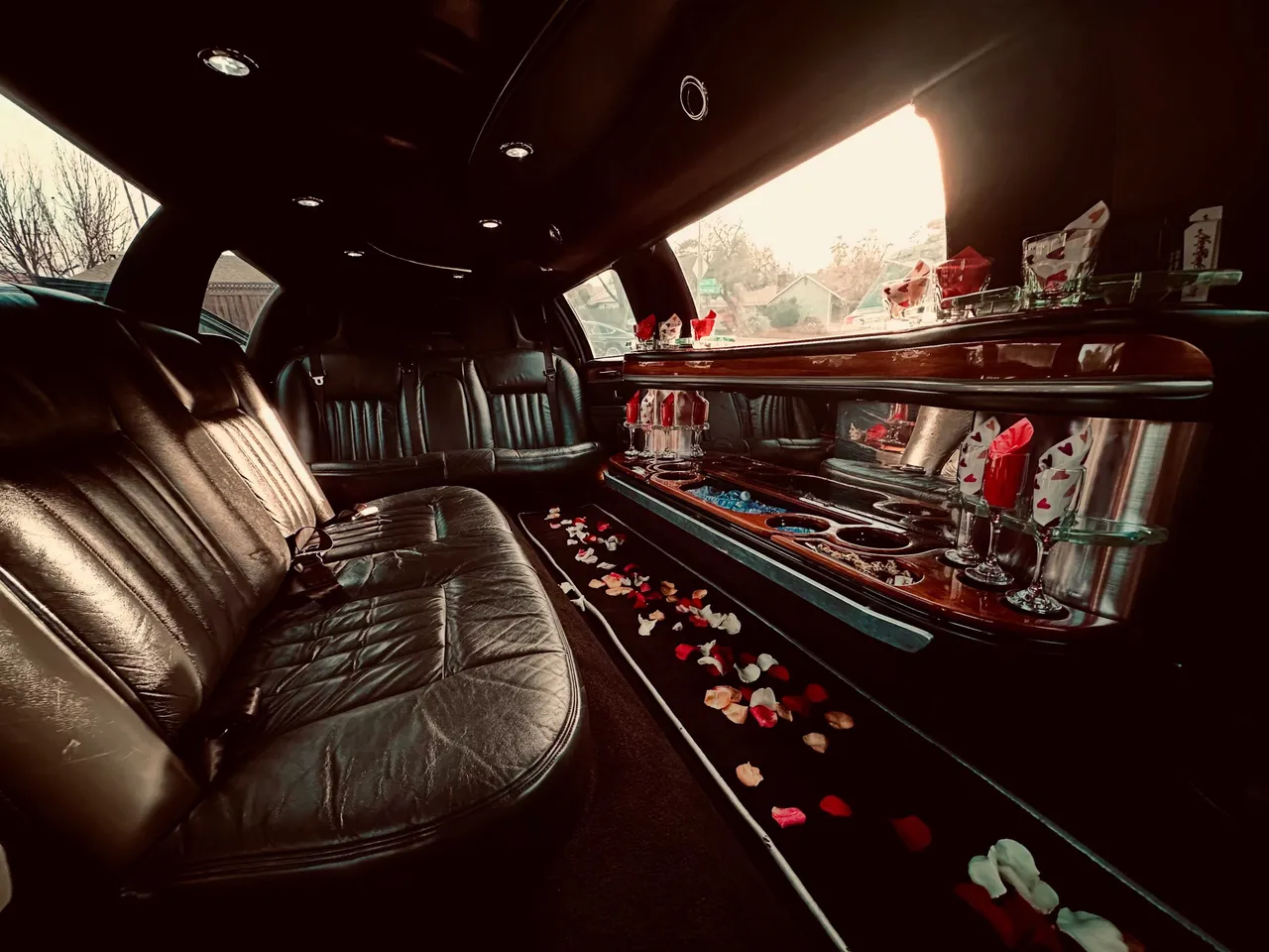 Lincoln Town Car Limousine interior with perimeter lounge seating, cup holders and bar area for limo rental in Hickman, CA