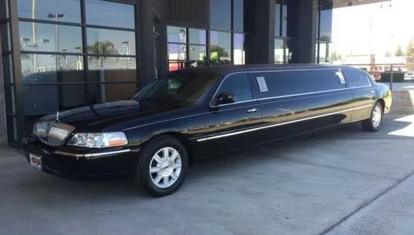 The black Lincoln Town Car Limousine, showing tinted windows