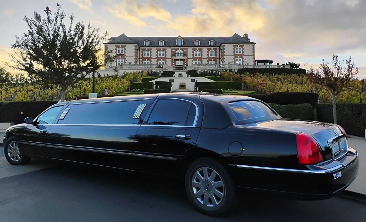 Black Lincoln Town Car Stretch Limousine with tinted windows for party bus rental in Mather, CA