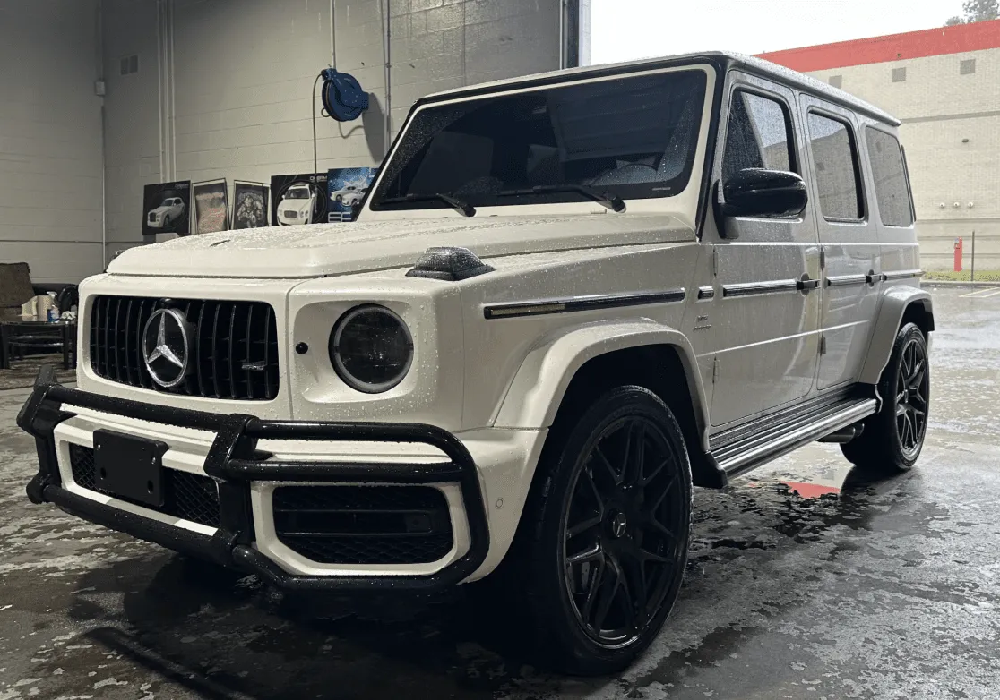 White Mercedes-Benz G Wagon with running boards for exotic and luxury car rental in Southfield, MI