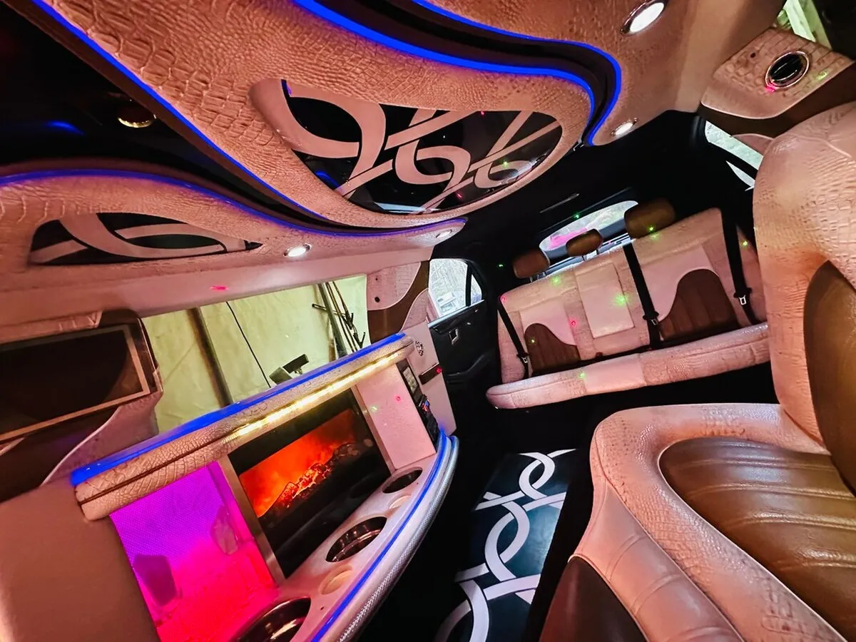 Mercedes-Benz Jet Doors Limousine interior with perimeter lounge seating and LED accent lighting for limo rental