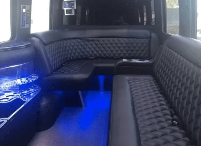 Mercedes-Benz Limousine Sprinter interior with sofa-style seating, cup holders and LED accent lighting for party bus rental in Paso Robles, CA
