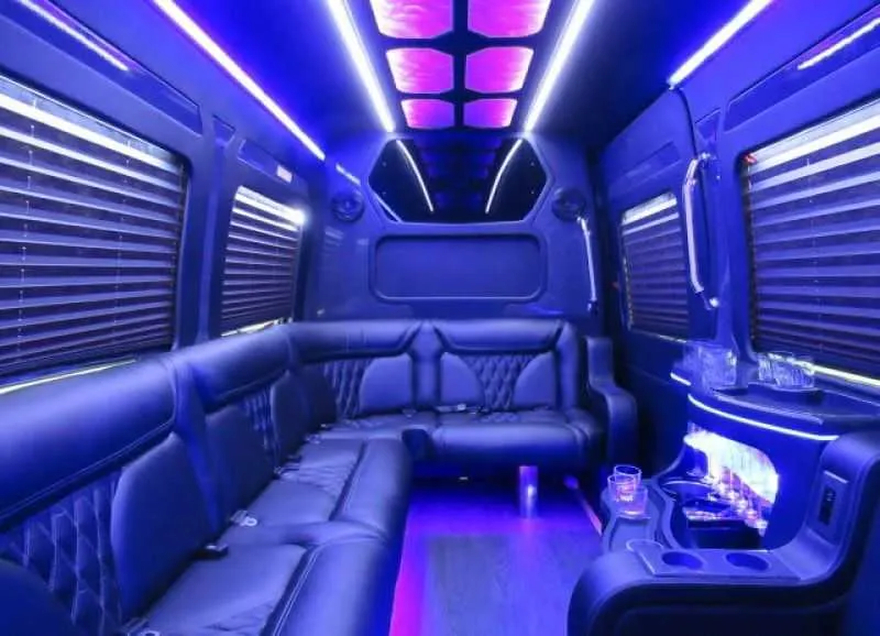 Mercedes-Benz Limousine Sprinter interior with perimeter lounge seating, window shades and LED accent lighting for party bus rental in Keyes, CA
