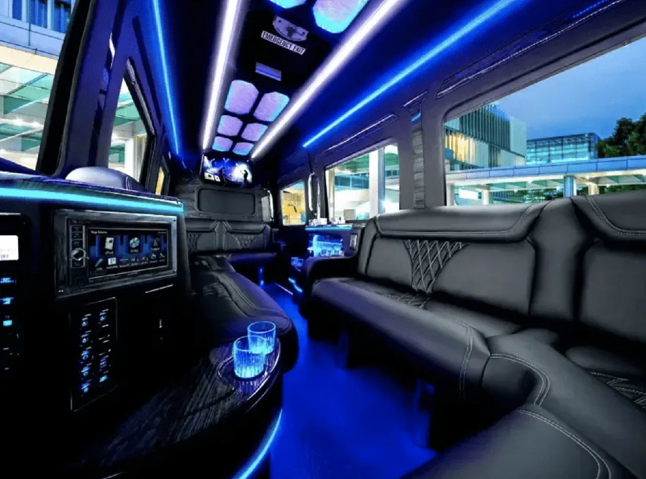 Mercedes-Benz Limousine Sprinter interior with sofa-style seating, LED accent lighting and LED ceiling lighting for party bus rental in Fresno, CA