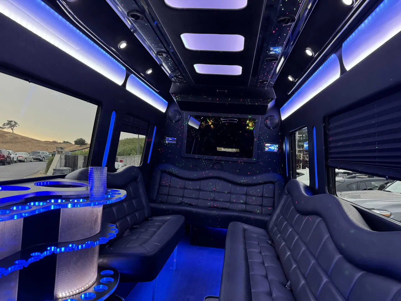 Mercedes-Benz Party Bus interior with perimeter lounge seating, window shades and LED accent lighting, photo 5 for party bus rental in Mather, CA