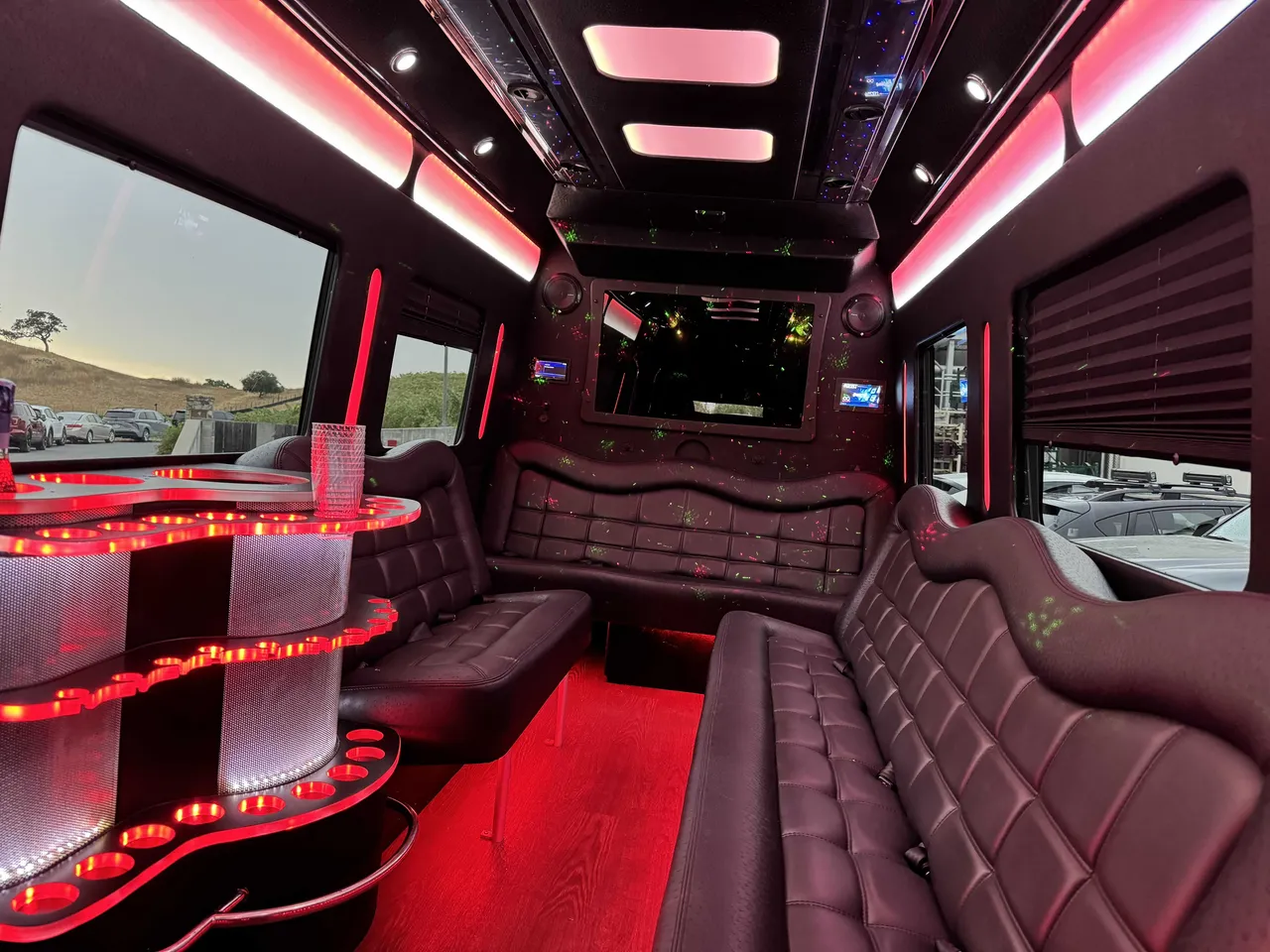 Mercedes-Benz Party Bus interior with perimeter lounge seating, window shades and LED accent lighting, photo 6 for party bus rental in Mather, CA