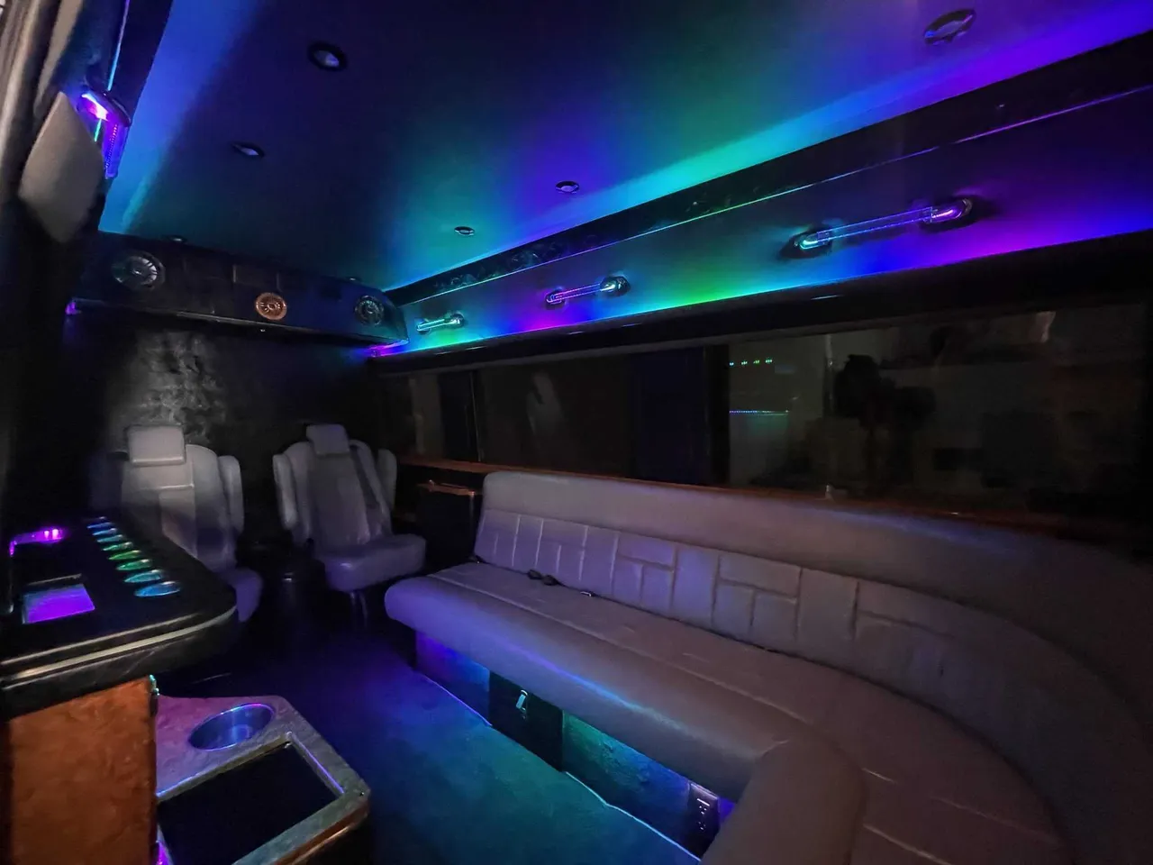 Mercedes-Benz Sprinter Limousine interior with sofa-style seating, captain's chairs and LED accent lighting, photo 2 for party bus rental