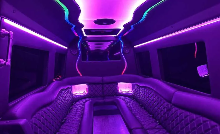 Mercedes-Benz Sprinter Limousine interior with perimeter lounge seating and LED accent lighting for limo rental in Dutch Flat, CA