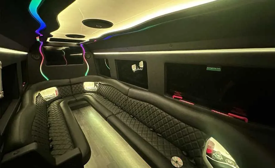 Mercedes-Benz Sprinter Limousine interior with perimeter lounge seating, LED accent lighting and bar area for limo rental in Dutch Flat, CA