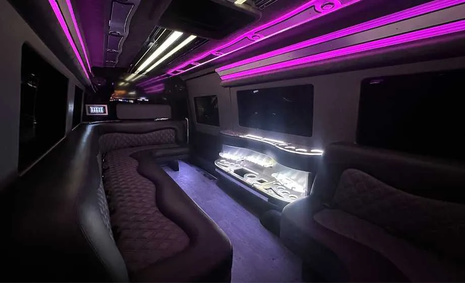 Mercedes-Benz Sprinter Limousine interior with perimeter lounge seating, LED accent lighting and bar area, photo 3 for limo rental in Dutch Flat, CA