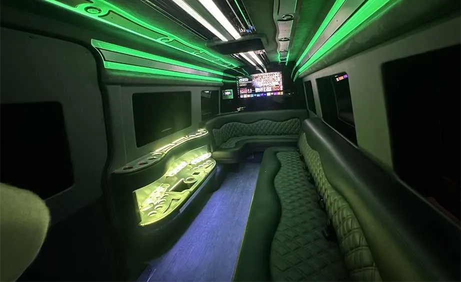 Mercedes-Benz Sprinter Limousine interior with perimeter lounge seating, LED accent lighting and bar area, photo 4 for limo rental in Dutch Flat, CA