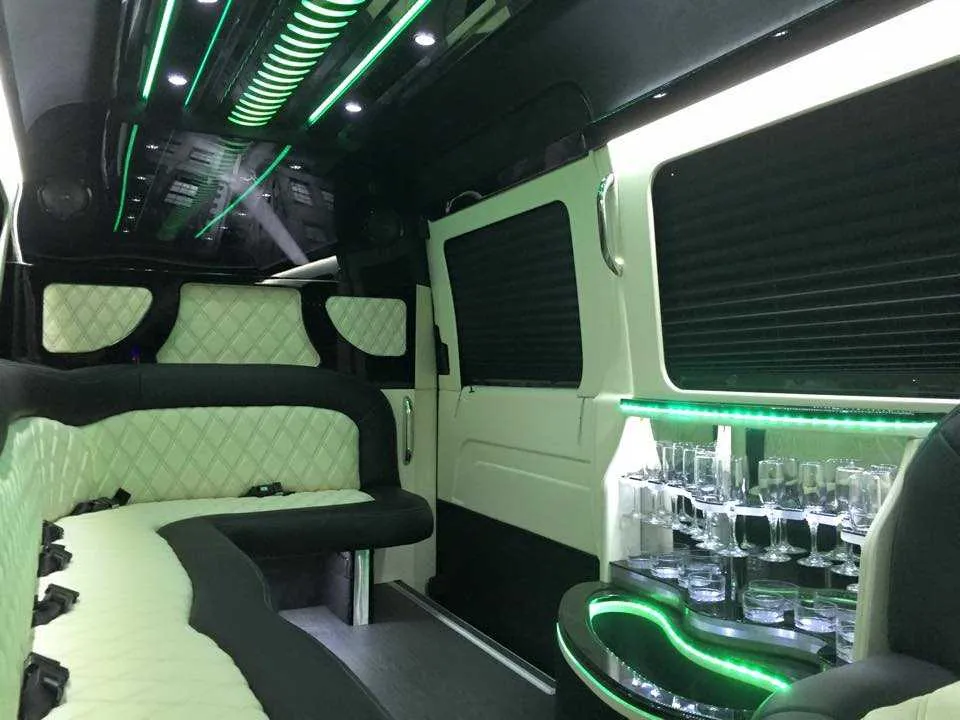 Mercedes Sprinter Limousine interior with perimeter lounge seating, sofa-style seating and window shades, photo 2 for party bus rental